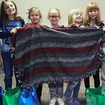 Girl Scouts make no-sew fleece tied blanket to donate