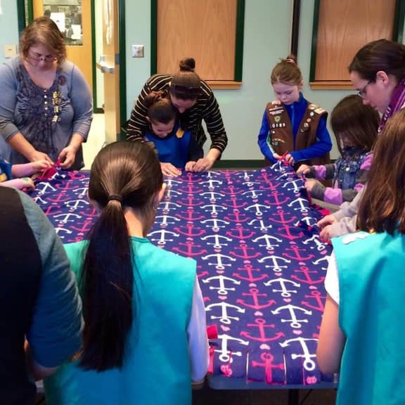 Girl Scouts Making DIY No-sew blankets.